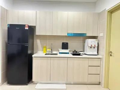 a kitchen with a black refrigerator and a sink at Vivo Soho Suite-5pax-Next to Midvalley, KL center in Kuala Lumpur