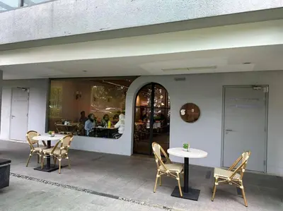 a patio with tables and chairs in front of a restaurant at Vivo Soho Suite-5pax-Next to Midvalley, KL center in Kuala Lumpur
