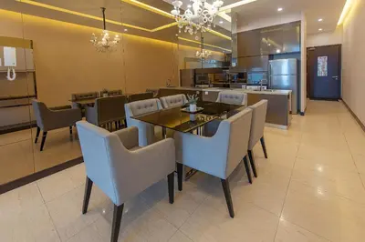 a dining room with a table and chairs and a kitchen at 1-6pax Dorsett KL 3mins to Pavilion Infinity Pool in Kuala Lumpur