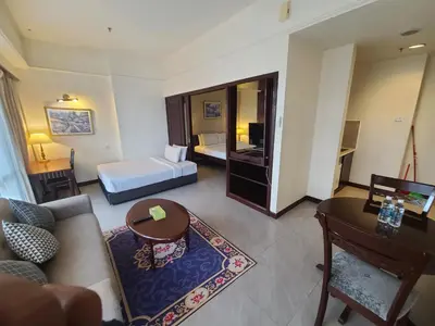 a living room with a couch and a bed at Premier CityView Times Square Apartment KL in Kuala Lumpur