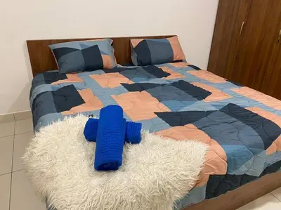 a bed with a blue object on top of it at Ampang 4-5 pax in Ampang Point in Ampang