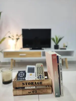 a pile of books sitting on a table with a glass of milk at Vivo Soho Suites by Luvit Stay in Kuala Lumpur