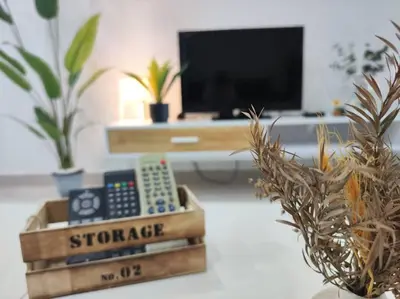 a remote control sitting on a table in a living room at Vivo Soho Suites by Luvit Stay in Kuala Lumpur
