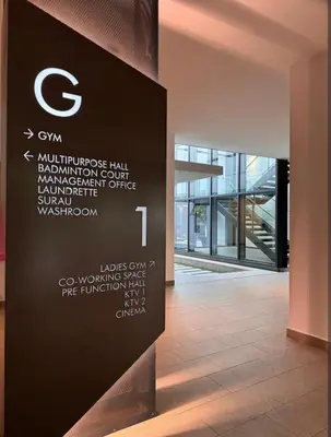 a wall in a building with a sign in a hallway at M Vertica By Seroja Coliving in Kuala Lumpur