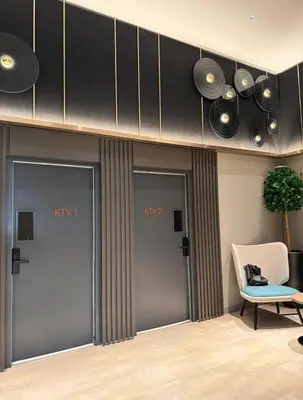 a room with four doors and a chair and a speaker at M Vertica By Seroja Coliving in Kuala Lumpur
