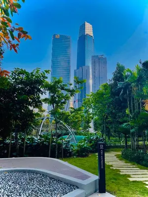 a park in a city with tall buildings at Agile Signature Suites KL in Kuala Lumpur