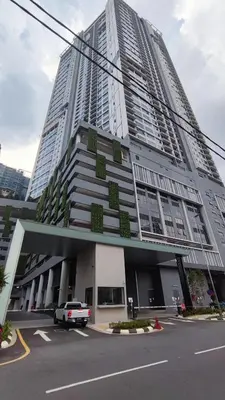 a tall building with a car parked in front of it at Agile Signature Suites KL in Kuala Lumpur