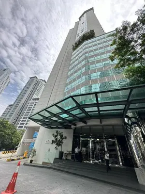 a tall building with a person walking in front of it at One Bukit Ceylon Bukit Bintang in Kuala Lumpur