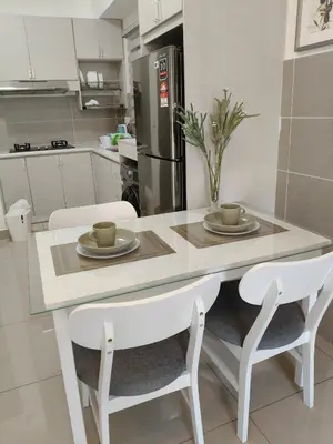 a kitchen with a table and two chairs and a table and chairsktop at M Centura Sentul Condominium Two Bedroom in Kuala Lumpur