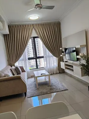 a living room with a couch and a tv at M Centura Sentul Condominium Two Bedroom in Kuala Lumpur