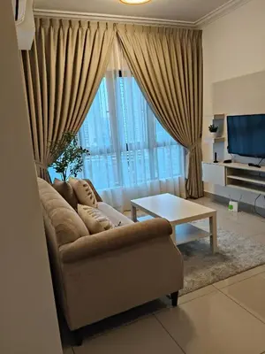 a living room with a couch in front of a large window at M Centura Sentul Condominium Two Bedroom in Kuala Lumpur