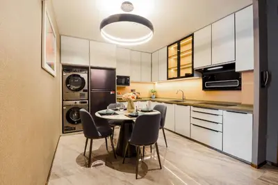 a kitchen with a table and chairs in a room at Atelier KLCC in Kuala Lumpur