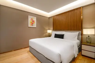a bedroom with a large white bed in it at Atelier KLCC in Kuala Lumpur