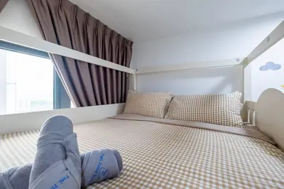 a person laying on a bed in a bedroom at Bea Bea's Kidz Dreamland Mini Horse 4br 11pax MRT in Kuala Lumpur