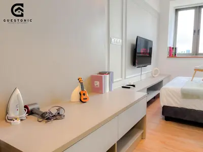 a bedroom with a desk with a bed and a tv at Riveria City KL Sentral by Guestonic in Kuala Lumpur
