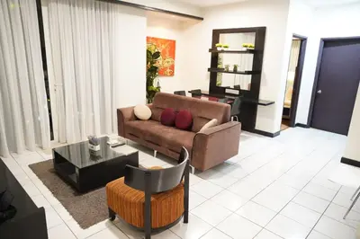 a living room with a couch and a table at The Luxe Apartment 2 Bedrooms in Kuala Lumpur