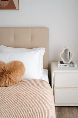 a white bed with a brown cat laying on it at Agile Bukit Bintang in Kuala Lumpur