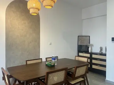 a dining room with a wooden table and chairs at Agile Premier Suites KL in Kuala Lumpur