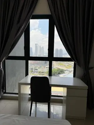 a desk with a chair in front of a window at KLCC view appartment in Kuala Lumpur