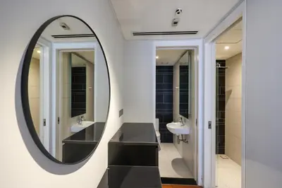 a bathroom with two sinks and a large mirror at Anggun Residences Serviced Suites by GB in Kuala Lumpur