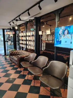 a salon with leather chairs and a flat screen tv at Platinum 2 KLCC By Natol Chain Of Homestays in Kuala Lumpur