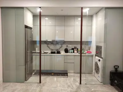 a kitchen with white cabinets and a washing machine at Platinum 2 KLCC By Natol Chain Of Homestays in Kuala Lumpur