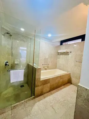 a bathroom with a shower and a tub and a sink at Jalan imbi Suites At Times Square KL in Kuala Lumpur