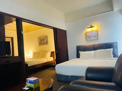 a hotel room with a bed and a chair at Jalan imbi Suites At Times Square KL in Kuala Lumpur