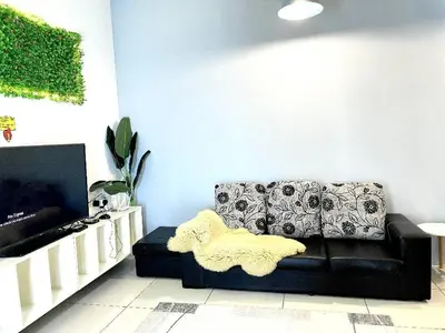 a living room with a couch and a tv at VR3 Sunway Velocity Spacious Apt\u4e2d\u6587\u623f\u6771 in Kuala Lumpur
