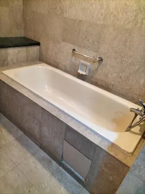 a white bath tub in a bathroom at Times Square Suite KL in Kuala Lumpur