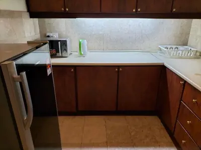 a kitchen with a black refrigerator and a microwave at Times Square Suite KL in Kuala Lumpur