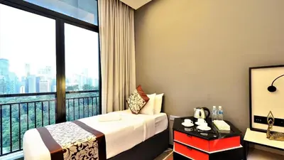 a hotel room with a bed and a large window at Menara M101 Dang Wangi Kuala Lumpur in Kuala Lumpur