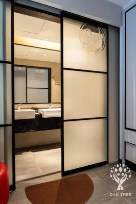 a bathroom with a sliding glass door with two sinks at Menara M101 Dang Wangi Kuala Lumpur in Kuala Lumpur