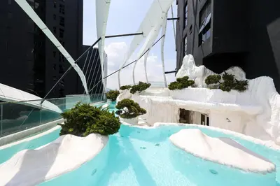 a balcony with snow covered chairs and plants on a building at Arte Mont Kiara By Luxe Home in Kuala Lumpur