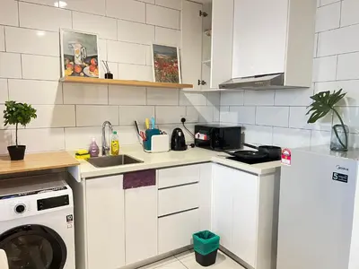 a kitchen with a sink and a washing machine at Arte Mont Kiara By Luxe Home in Kuala Lumpur