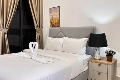a bedroom with a bed with a heart towel on it at Comfy studio suite Free Parking Netflix Trion C3208St KL in Kuala Lumpur