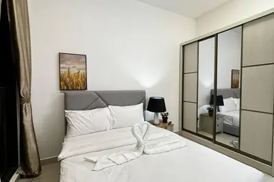 a bedroom with a large white bed and a mirror at Comfy studio suite Free Parking Netflix Trion C3208St KL in Kuala Lumpur