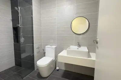 a bathroom with a toilet and a sink and a mirror at Comfy studio suite Free Parking Netflix Trion C3208St KL in Kuala Lumpur