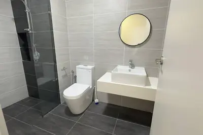 a bathroom with a toilet and a sink and a mirror at Comfy studio suite Free Parking Netflix Trion C3208St KL in Kuala Lumpur