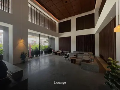 a lobby with tables and chairs in a building at Scenic Garden Balcony EST Bangsar Studio for 2 in Kuala Lumpur