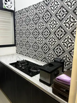 a kitchen with a stove and a tile wall at Seasons Gardens Wangsa Maju, KL - 3 bedroom apartment in Kuala Lumpur