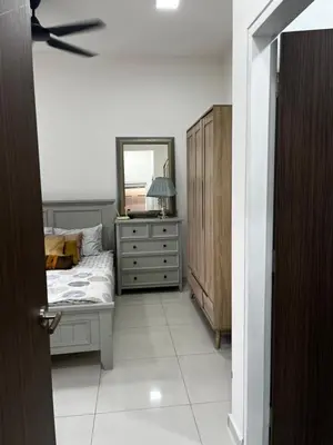 a bedroom with a bed and a dresser and a mirror at Seasons Gardens Wangsa Maju, KL - 3 bedroom apartment in Kuala Lumpur