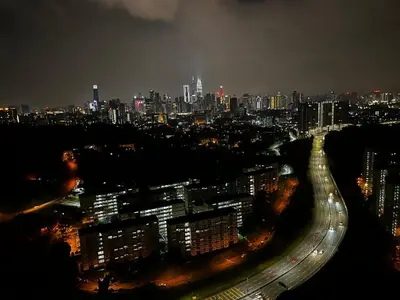 a city lit up at night with traffic on a freeway at Seasons Gardens Wangsa Maju, KL - 3 bedroom apartment in Kuala Lumpur