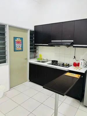 a kitchen with black cabinets and a counter top at VUE Residences Hkl Klcc view in Kuala Lumpur