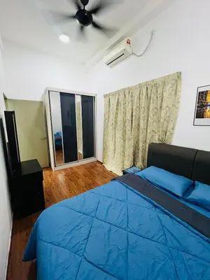a bedroom with a blue bed and a ceiling fan at VUE Residences Hkl Klcc view in Kuala Lumpur