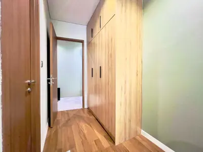a hallway with a wooden door in a room at Sky Suites Chill 3BR Suite at KLCC in Kuala Lumpur