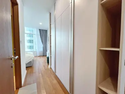 a hallway with a room with a bed and a closet at Sky Suites Dreamy 3BR Suite at KLCC in Kuala Lumpur