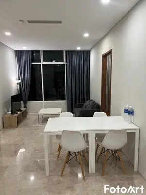 a living room with a white table and chairs at Sky Suites KLCC by ARBA in Kuala Lumpur