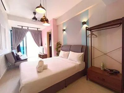 a bedroom with a large white bed and a chair at COL 18A Modern Balcony KLCC View Infinity Pool in Kuala Lumpur