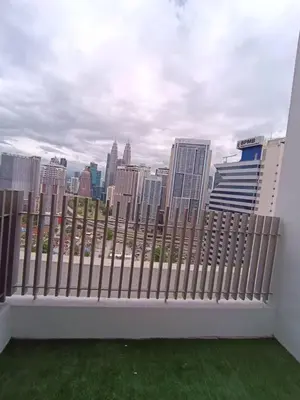 a white fence with a view of the city at COL 18A Modern Balcony KLCC View Infinity Pool in Kuala Lumpur